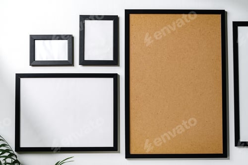 Preview: Set of black frames on white wall with copy space
