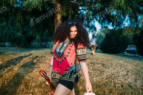 Preview: Young woman with guitar in park