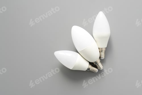 Preview: Three lightbulbs on gray background, close up