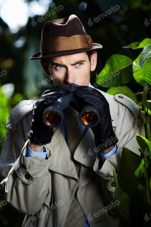 Preview: Checking up on you...Private investigator using binoculars to spy on someone from the bushes.