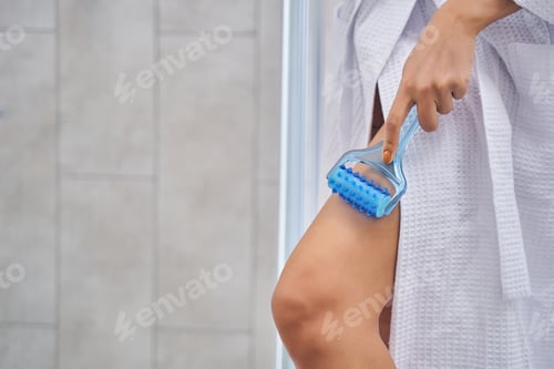 Preview: Young woman hand using body massage roller