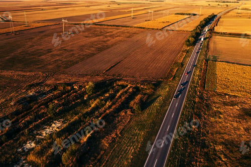 Preview: Cars driving down the road through countryside in autumn