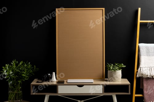 Preview: Wood empty frame with copy space, plants and technology devices on desk against black wall