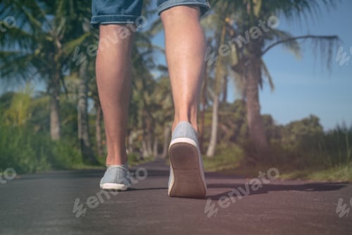 Preview: Detail Of A Man'S Legs While Walking Through A Street With Palm - Trees.
