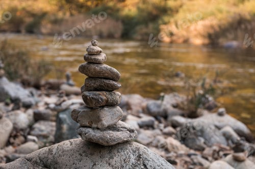 Preview: Balanced stack of pyramid stones on river