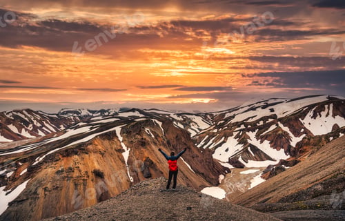 Preview: Hiker woman standing on the peak with volcanic mountain range on Blanhjukur trail