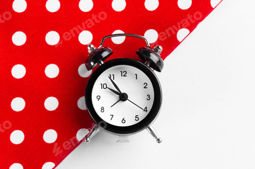 Preview: Vintage black alarm clock on a color block background