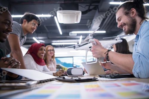 Preview: multiethnic business team learning about drone technology