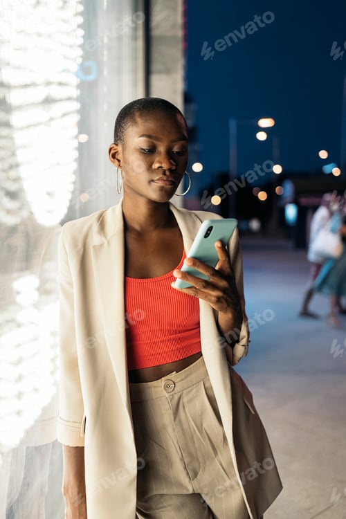Preview: ashionable young woman with short hair using her phone