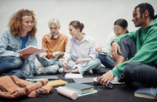 Preview: Happy teenage girl with copybook looking at her African American boyfriend