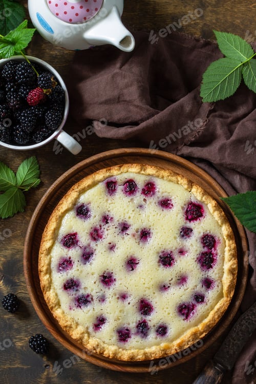 Preview: Homemade pie. Sweet pie with blackberry on rustic wooden table. Top view flat lay background.