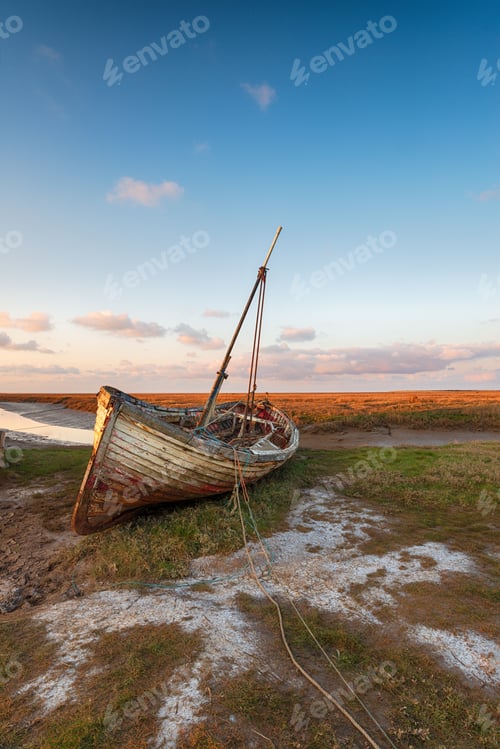 Preview: An old wooden fishing boat on the shore at Thornham harbour