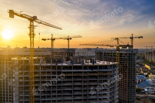 Preview: Construction site with cranes at sunset. Construction of an apartment building