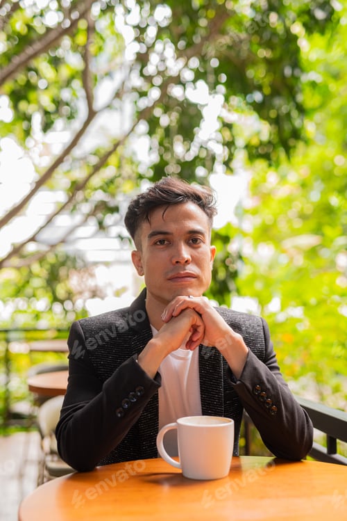 Preview: Portrait of handsome young businessman at coffee shop