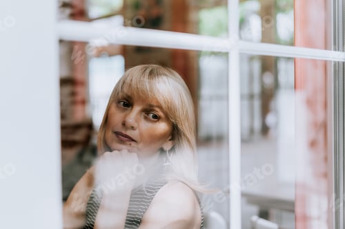 Preview: Senior Woman sits in front of the window. Looking sad and thoughtful. Mental health and depression