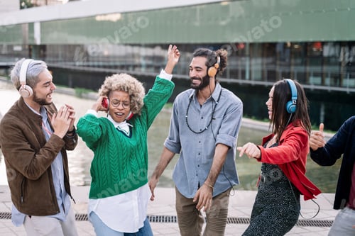 Preview: Group of young diverse friends listening to music, dancing and celebrating a street party