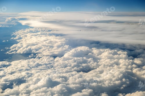 Preview: Aerial view of white puffy clouds viewed from an airplane.
