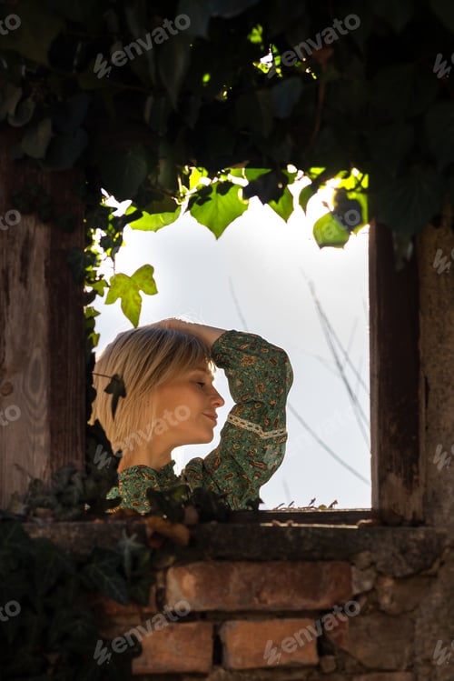 Preview: photo of a boho girl through an old window