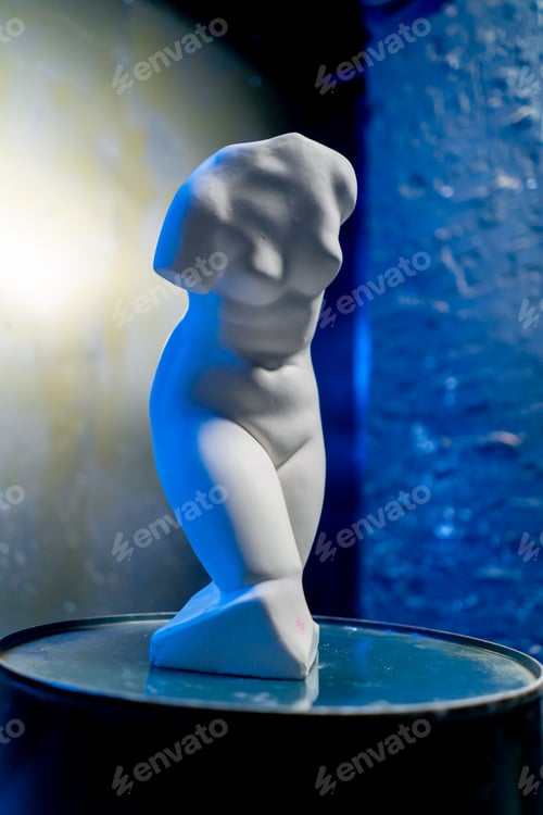 Preview: close-up white sculpture in the form of a body standing on a barrel museum exhibit performance art
