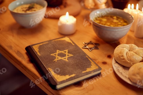 Preview: The book of Tanakh on dining table during Hanukkah celebration.