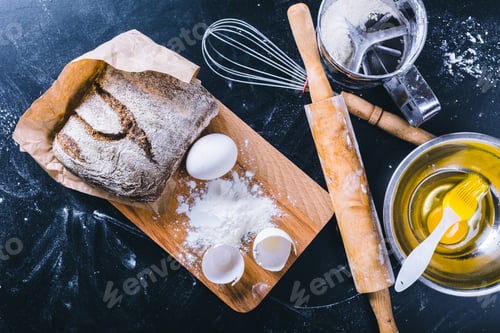 Preview: Baking bread with flour, eggs, and kitchen tools on wooden board in kitchen space