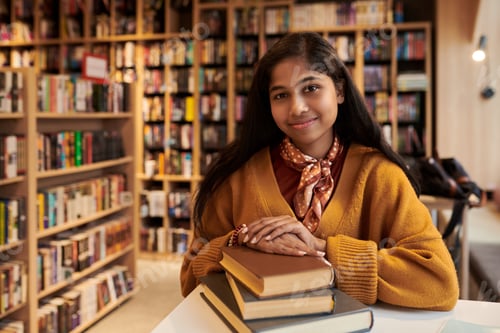 Preview: Portrait of Teenager Asian Girl Smiling While Sitting in Library