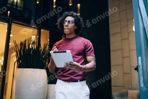 Preview: millennial hipster guy in spectacles using digital tablet