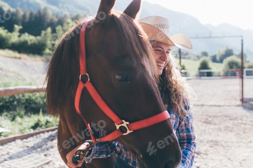 Preview: Young cowgirl leading horse in rural equestrian arena