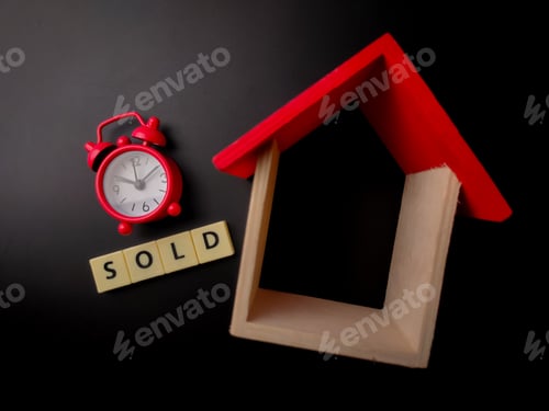 Preview: Wooden house and clock with word SOLD on black background