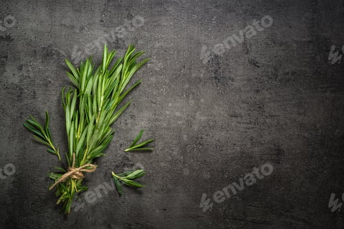 Preview: Rosemary sprig on a black kitchen table