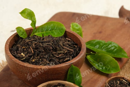 Preview: Dried tea leaves in wooden bowl