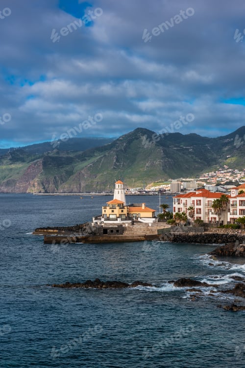 Preview: Marina da Quinta Grande, Madeira, Portugal. Seaside small village with lighthouse on rocky cliffs.