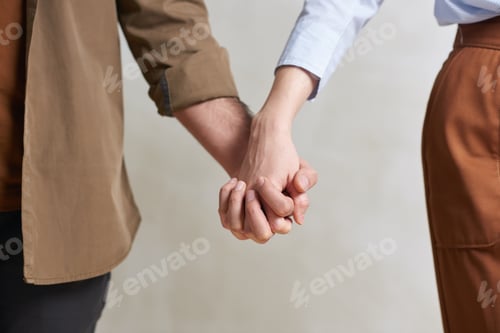 Preview: Unrecognizable Couple Holding Hands