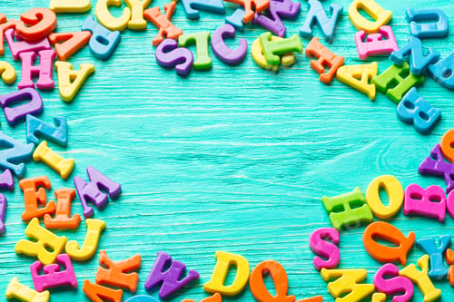Preview: Multiple colored letters on wooden table