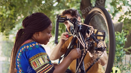 Preview: Motivated couple fixing damaged bicycle