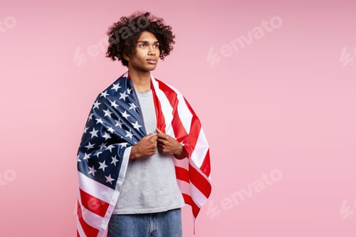 Preview: Young adult Black man expressing patriotism with American flag