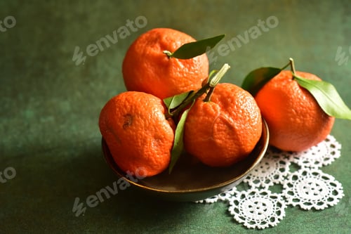 Preview: Fresh and ripe tangerines on green background