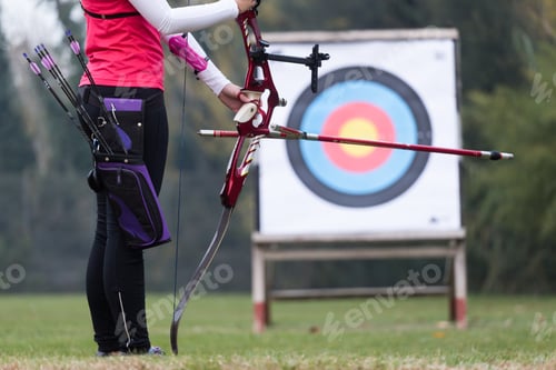 Preview: Female athlete practicing archery in stadium