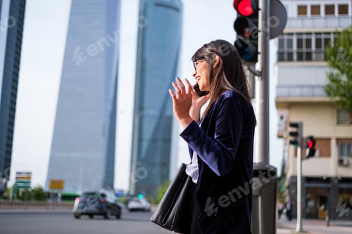 Preview: Young woman talking on the phone after work