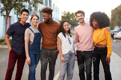 Preview: Six millennial hipster friends standing in a city street smiling to camera, three quarter length