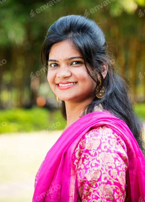 Preview: Outdoor portrait of beautiful young Indian girl in traditional dress.