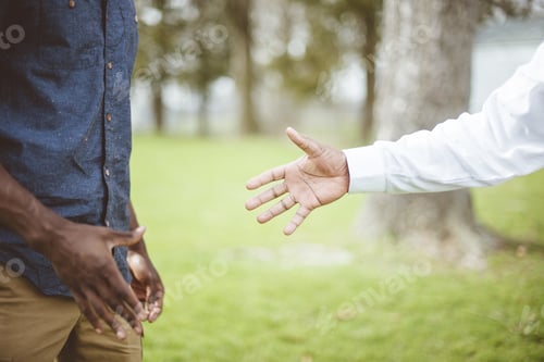 Preview: Closeup shot of a male lending his had to another male - support concept