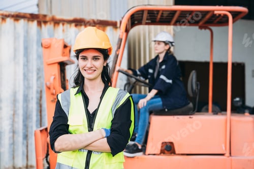 Preview: Portrait of industrial worker driving a forklift in the factory. Engineer is working and maintaining