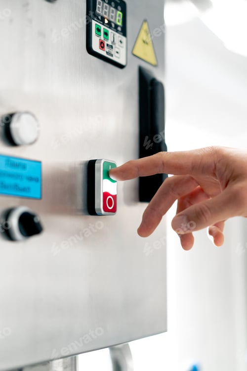 Preview: Close-up shot of a man's hand pressing the on and off button on fermentation machine with his finger