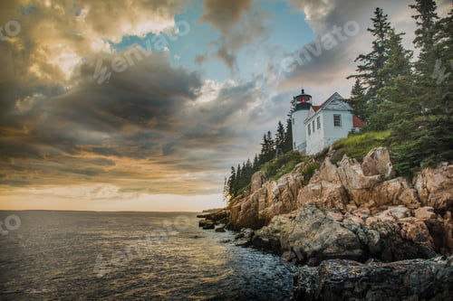 Preview: Beautiful shot of a white house on top of the cliff on the edge of the ocean under the cloudy sky