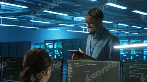 Preview: IT specialist in server farm ensuring valuable data remains shielded