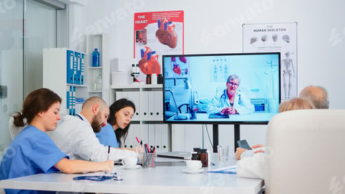Preview: Professional teamworkers watching instructional medical videos