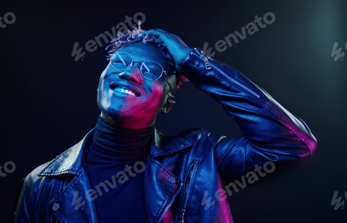 Preview: In glasses. Futuristic neon lighting. Young african american man in the studio