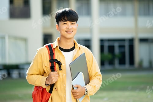 Preview: Smiling College Student with Laptop and Books on Campus