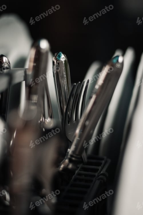 Preview: Vertical selective focus of forks and knives in the dishwashing machine.